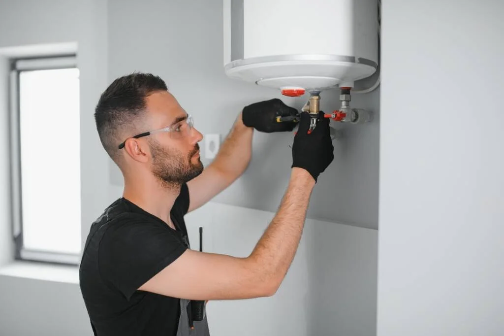 professional plumber checking a boiler and pipes 2025 03 18 14 07 24 utc 1 1024x682 1